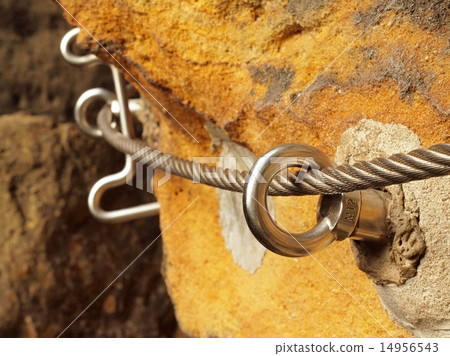 Ferrata, iron rope in anchor eye concreted in rock 14956543