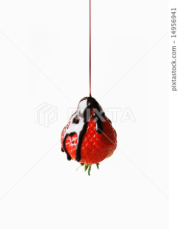 Chocolate licking strawberries 14956941