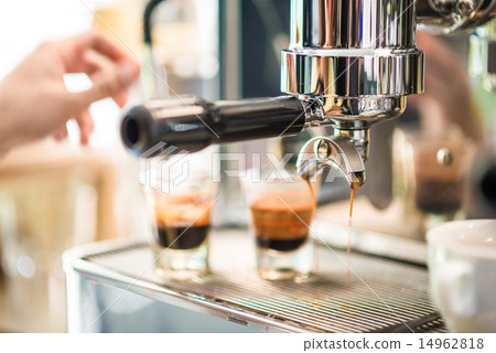 Coffee machine prepares espresso in coffeeshop 14962818