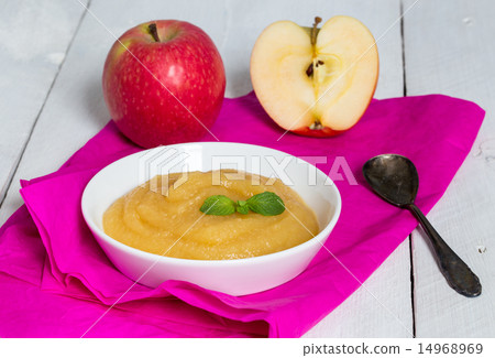 Applesauce on pink paper and spoon 14968969