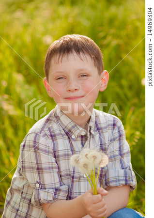 Boy on summer nature with dandelions smilling Boy on summer nature with dandelions smilling 14969304