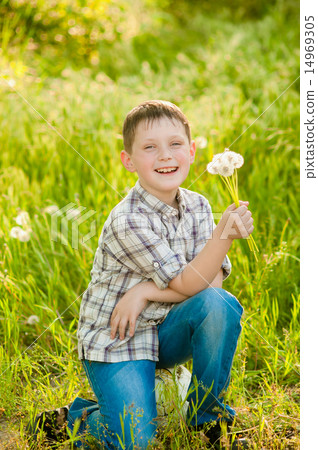 Boy on summer nature with dandelions smilling Boy on summer nature with dandelions smilling 14969305