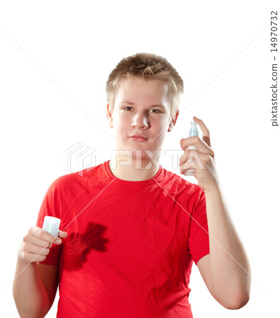 The boy, the teenager spraying fragrance perfume 14970732
