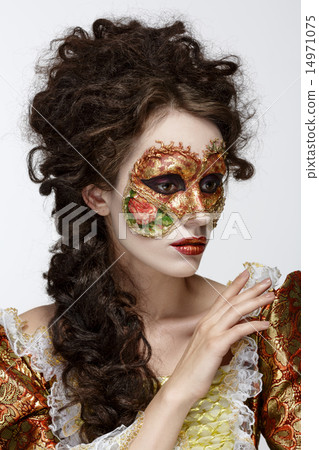 Venetian mask. Beautiful woman in vintage dress and a mask on hi 14971075