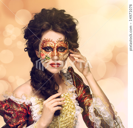 Venetian mask. Beautiful woman in vintage dress and a mask on hi 14971076