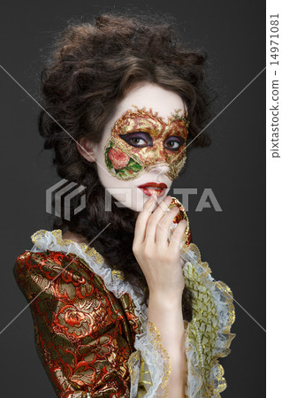 Venetian mask. Beautiful woman in vintage dress and a mask on hi 14971081