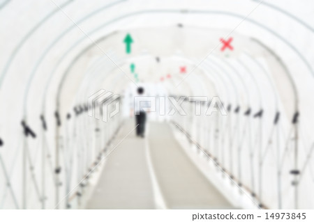 Blur image of Man walking under Canvas tunnel  14973845