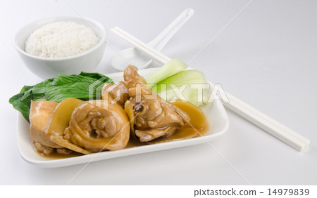 Chicken with rice and vegetables in background 14979839