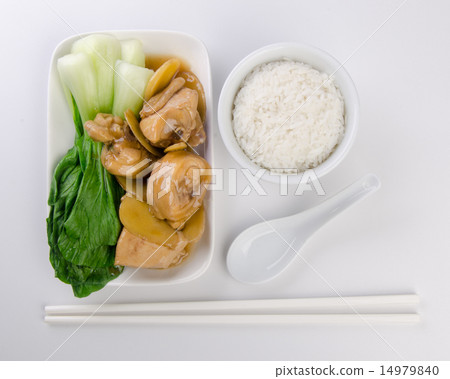 Chicken with rice and vegetables in background 14979840
