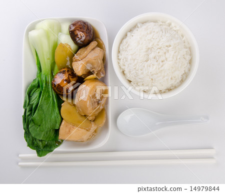 Chicken with rice and vegetables in background 14979844