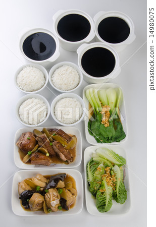 Chicken with rice and vegetables in background. 14980075