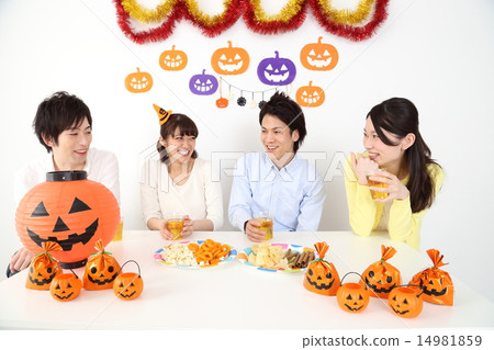 Young men and women drinking at a Halloween party 14981859
