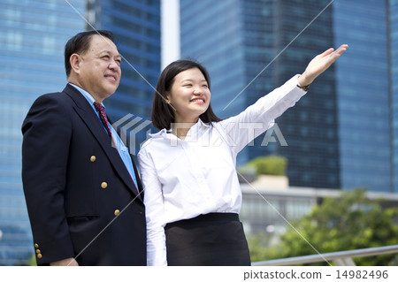 Asian businessman & female executive pointing 14982496