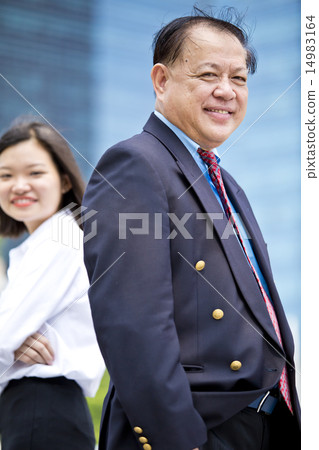 Asian businessman & female executive portrait 14983164