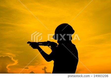 Silhouette boy holding shotgun with sun set. Silhouette boy holding shotgun with sun set. 14983206