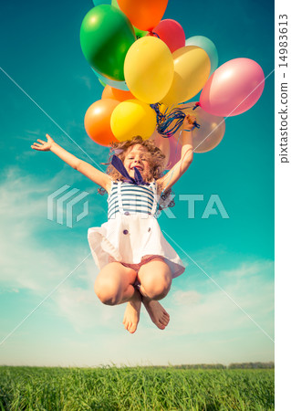 Child with toy balloons in spring field 14983613