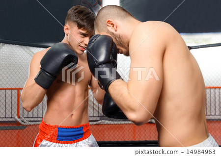 Boxers fight in a sparring 14984963