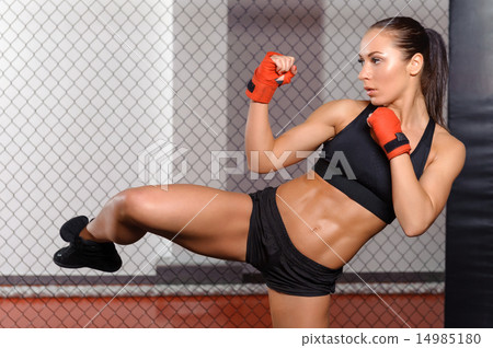 Female boxer fighting in a ring 14985180