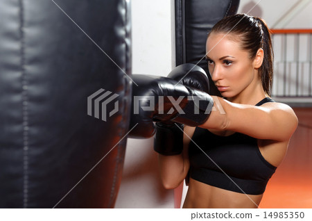 Female boxer with punching bag 14985350