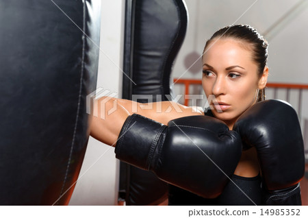 Female boxer with punching bag 14985352