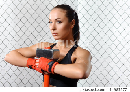 Sportswoman with a hummer in gym 14985377