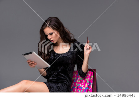 Beautiful young girl paying by credit card for shopping  14986445