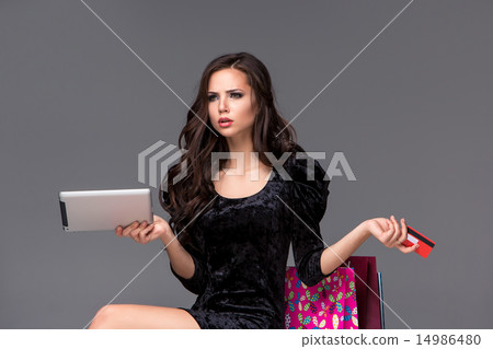 Beautiful young girl paying by credit card for shopping  14986480