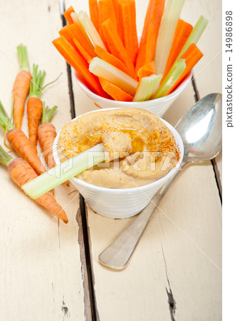 fresh hummus dip with raw carrot and celery fresh hummus dip with raw carrot and celery 14986898