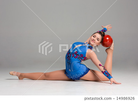 teenager doing gymnastics exercises with red gymnastic ball teenager doing gymnastics exercises with red gymnastic ball 14986926