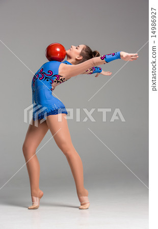teenager doing gymnastics exercises with red gymnastic ball teenager doing gymnastics exercises with red gymnastic ball 14986927