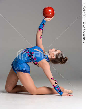 teenager doing gymnastics exercises with red gymnastic ball teenager doing gymnastics exercises with red gymnastic ball 14986928