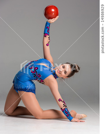 teenager doing gymnastics exercises with red gymnastic ball teenager doing gymnastics exercises with red gymnastic ball 14986929
