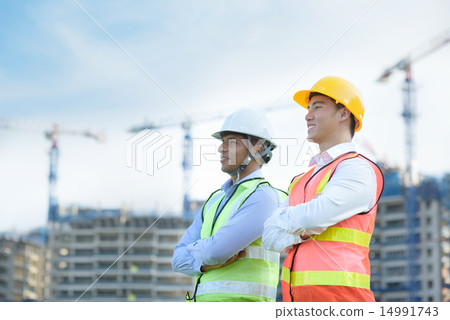 Construction team in front of construction site 14991743