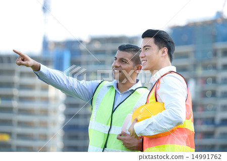 Construction team in front of construction site 14991762