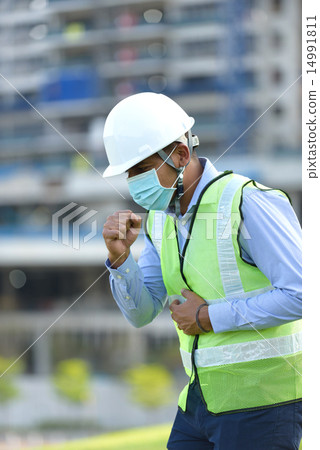 Indian construction worker coughing 14991811