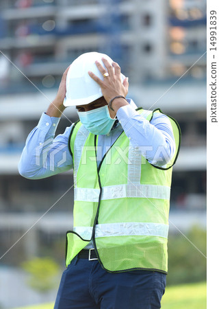 Indian construction worker having a headache 14991839