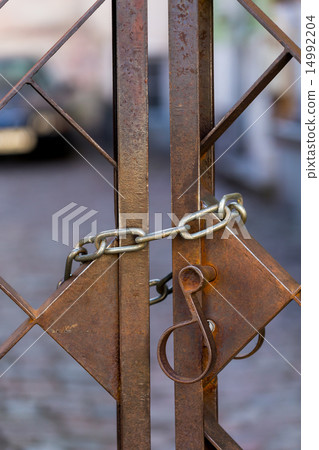 Old metal lock on chain Old metal lock on chain 14992204