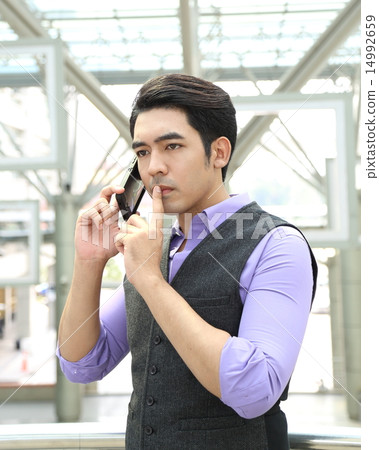 Man talking on phone and thinking Man talking on phone and thinking 14992659