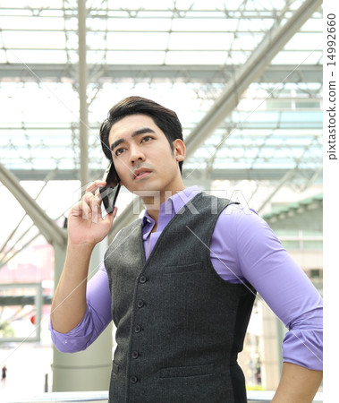 Man looking up and talking on phone Man looking up and talking on phone 14992660