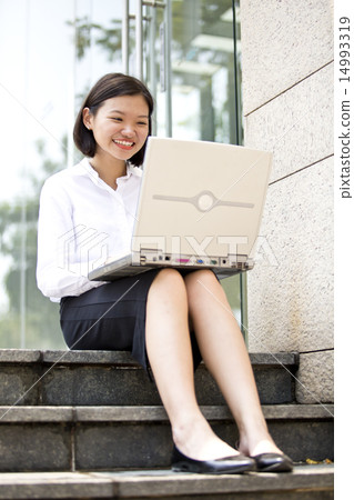 Asian young female executive using laptop Asian young female executive using laptop 14993319