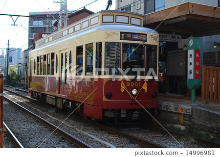 A retro tram that stops at a stop 14996981