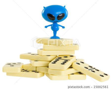 Blue toy alien on a heap from dominoes 15002561