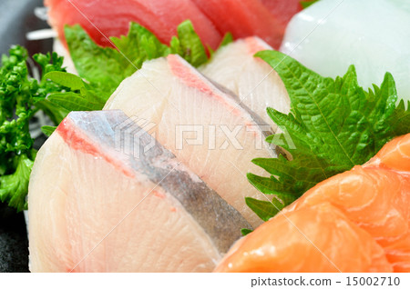 Assorted assortment of sashimi with a detailed variety unknown, tuna, squid, tomato and salmon. Assorted assortment of sashimi with a detailed variety unknown, tuna, squid, tomato and salmon. 15002710