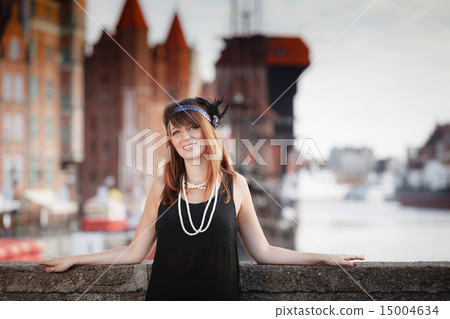 Flapper girl woman in1920s style standing on the street Flapper girl woman in1920s style standing on the street 15004634