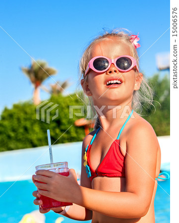 Child drinking near swimming pool. Child drinking near swimming pool. 15006576