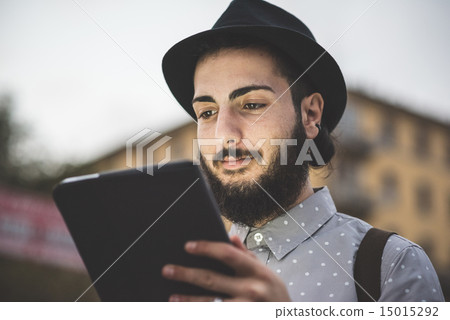 young handsome hipster gay modern man using tablet young handsome hipster gay modern man using tablet 15015292