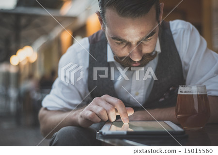 handsome big moustache hipster man using tablet 15015560