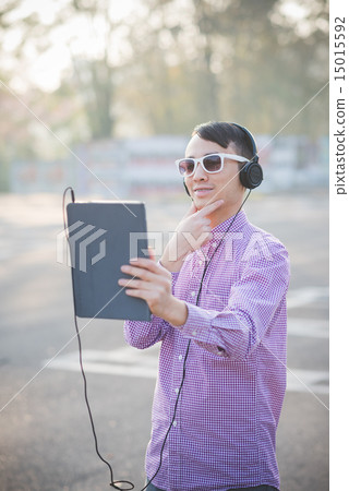 young crazy funny asian man in town outdoor lifestyle listening young crazy funny asian man in town outdoor lifestyle listening 15015592