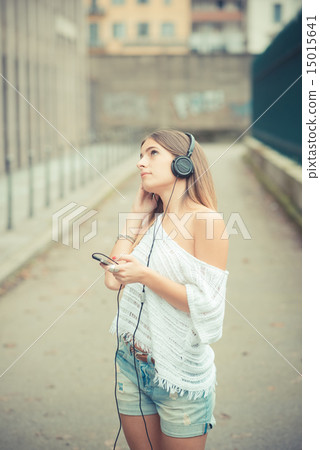 young beautiful woman girl autumn listening music 15015641