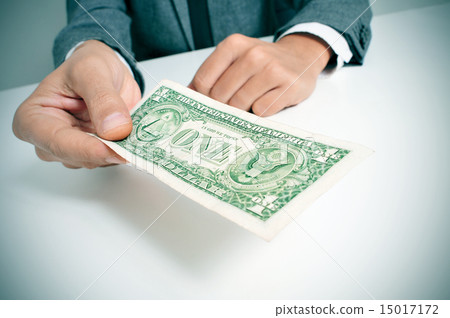 man in suit offering a one US dollar bill 15017172